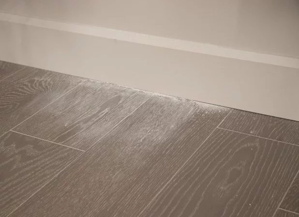 Drywall dust embedded in wood